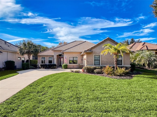 mediterranean / spanish house featuring a front yard