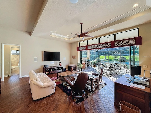 living room with a wealth of natural light, ceiling fan, and hardwood / wood-style flooring