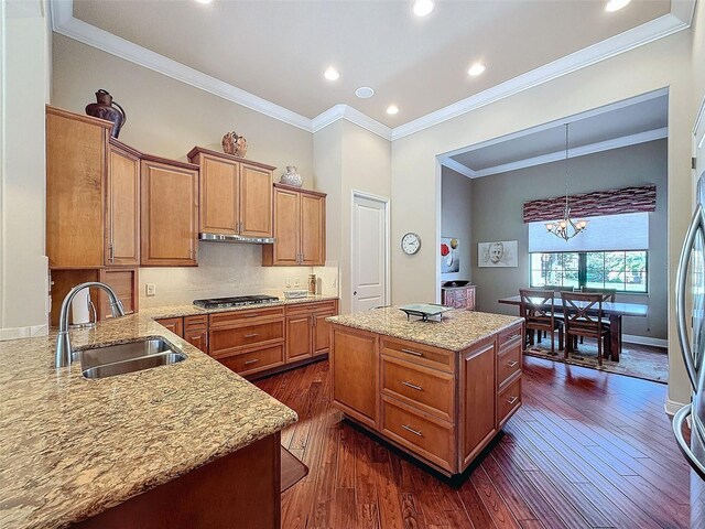 kitchen with a center island, dark hardwood / wood-style flooring, sink, and an inviting chandelier