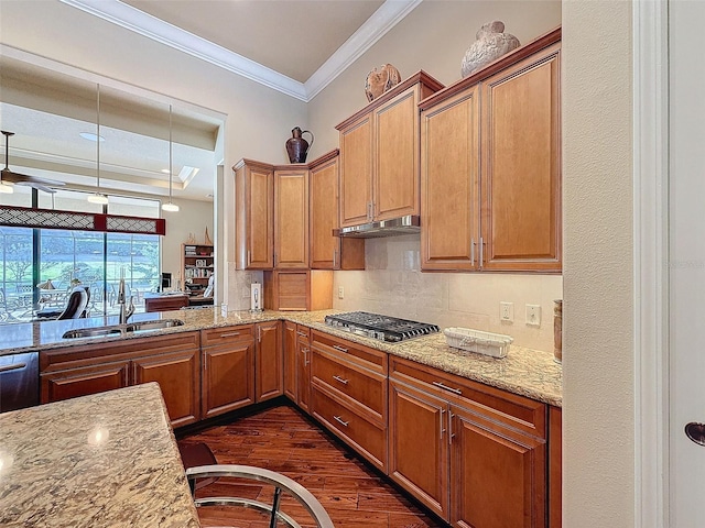 kitchen with dark hardwood / wood-style floors, light stone counters, stainless steel gas stovetop, and sink