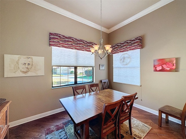 dining area with dark hardwood / wood-style flooring, an inviting chandelier, and ornamental molding