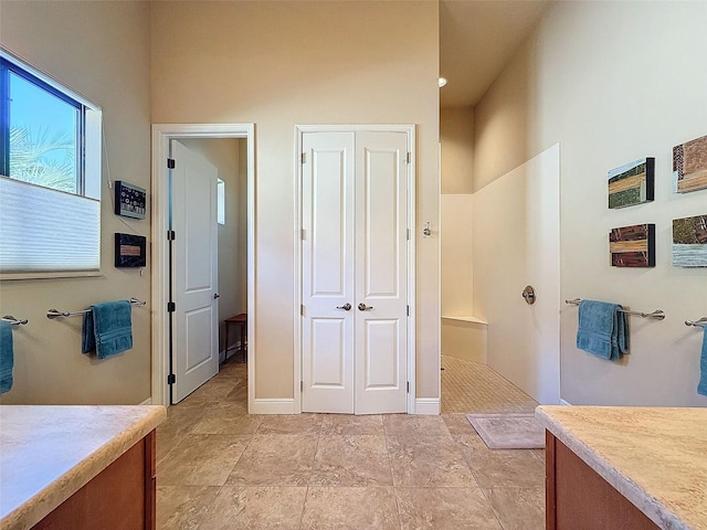 bathroom with vanity and a shower