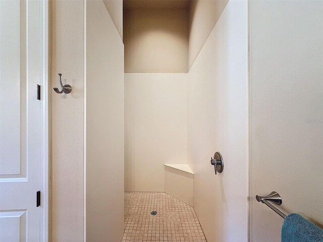 bathroom with tile patterned flooring and walk in shower