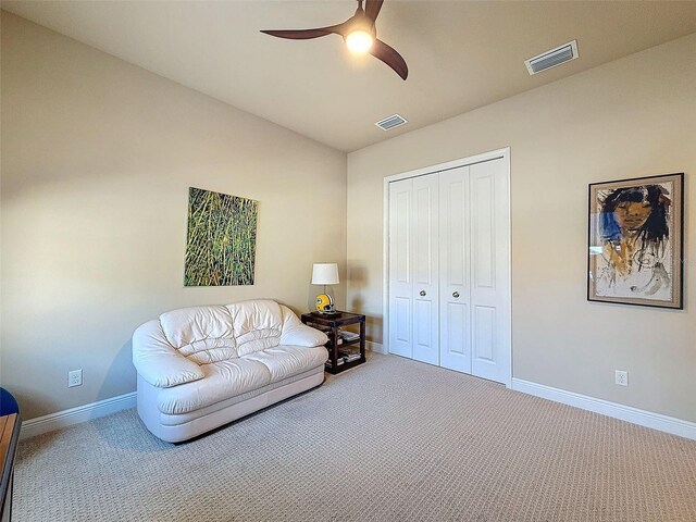 sitting room with ceiling fan, carpet, and lofted ceiling