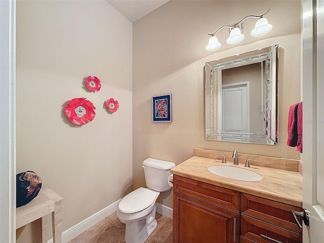 bathroom featuring tile patterned flooring, vanity, and toilet