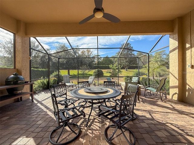 view of patio featuring ceiling fan and a lanai