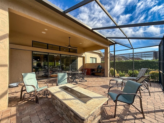 view of patio / terrace with ceiling fan and a lanai