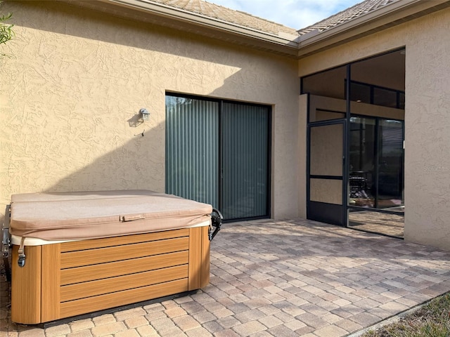 view of patio / terrace with a hot tub