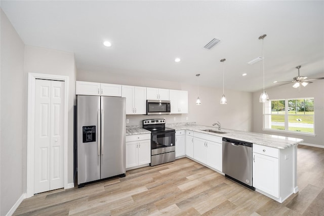 kitchen with sink, white cabinetry, stainless steel appliances, decorative light fixtures, and kitchen peninsula