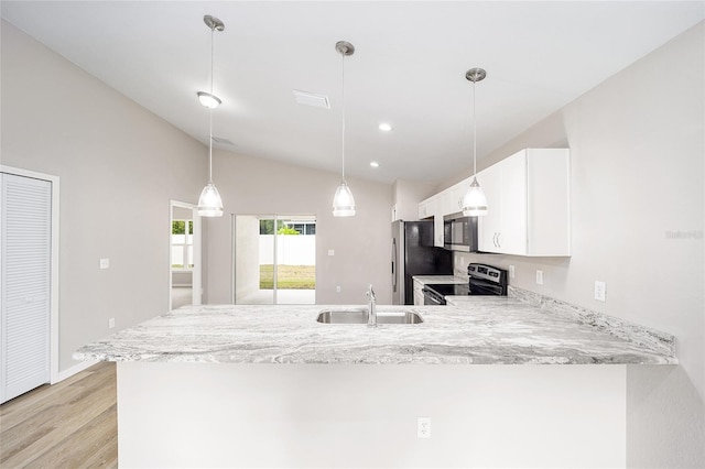 kitchen with sink, white cabinetry, stainless steel appliances, vaulted ceiling, and kitchen peninsula