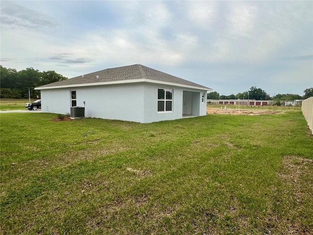 view of home's exterior with central AC and a lawn