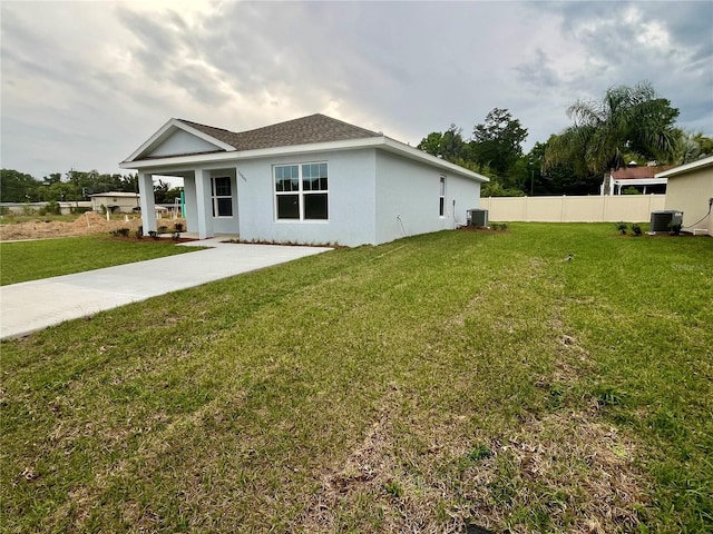 exterior space with cooling unit and a front yard