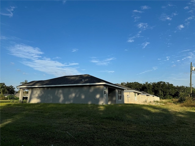 view of property exterior featuring a lawn