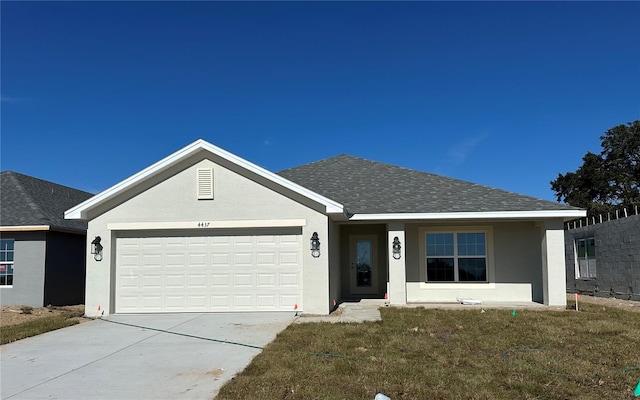 ranch-style house with a front yard and a garage