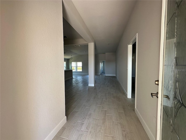 hallway with hardwood / wood-style flooring