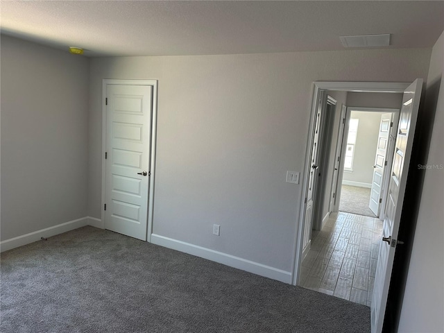 empty room with carpet flooring