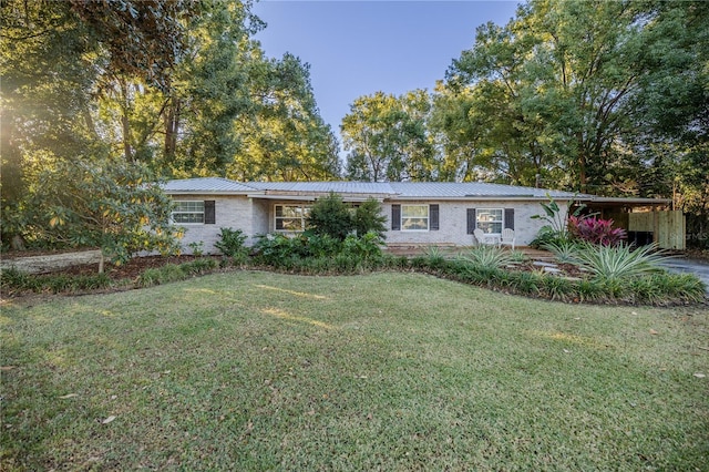 ranch-style house featuring a carport and a front yard