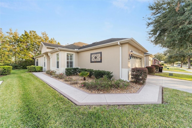 view of property exterior with a garage and a lawn