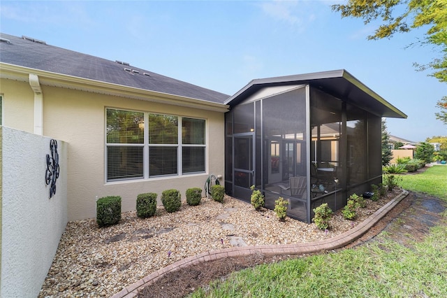 view of side of property featuring a sunroom