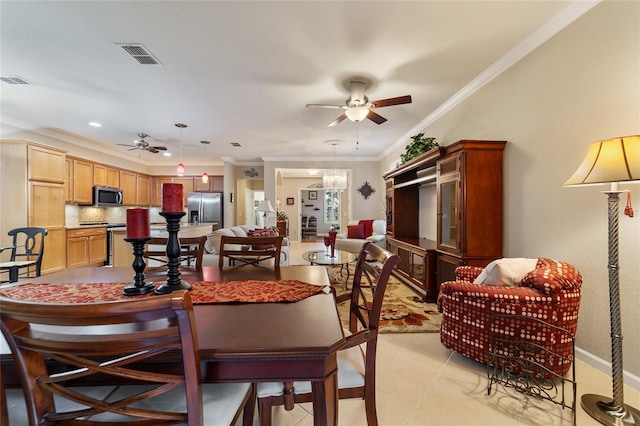 dining area with light tile patterned floors and crown molding