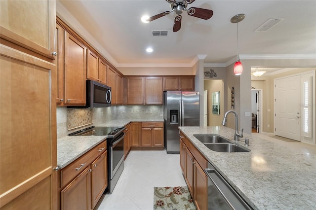 kitchen featuring backsplash, stainless steel appliances, light stone counters, and sink