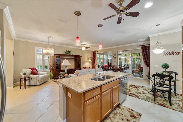 kitchen with decorative light fixtures, sink, and a wealth of natural light