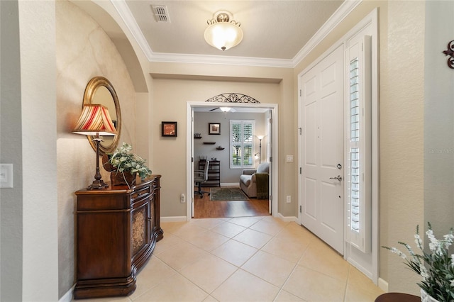 entrance foyer featuring light hardwood / wood-style floors and crown molding