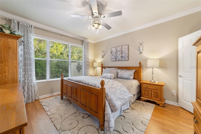 bedroom featuring light hardwood / wood-style floors, ceiling fan, and ornamental molding