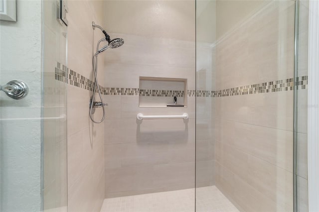 bathroom with tiled shower