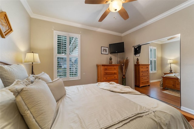 bedroom featuring a closet, dark hardwood / wood-style floors, ceiling fan, and ornamental molding