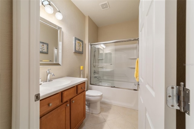 full bathroom featuring shower / bath combination with glass door, vanity, tile patterned floors, and toilet