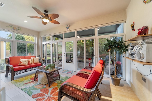 sunroom featuring ceiling fan