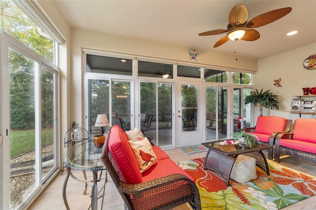 sunroom featuring ceiling fan