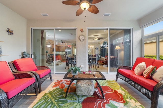 interior space featuring outdoor lounge area and ceiling fan