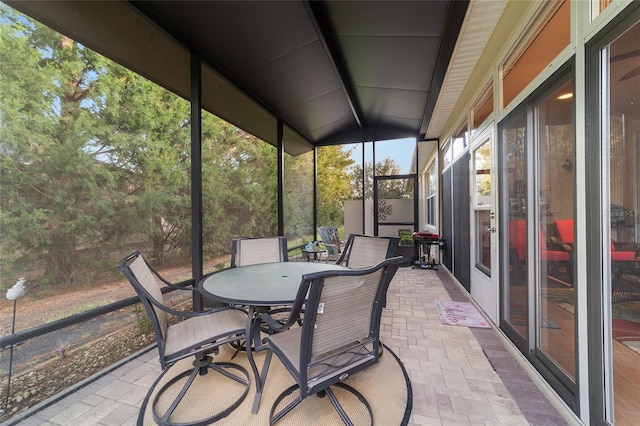 sunroom featuring vaulted ceiling