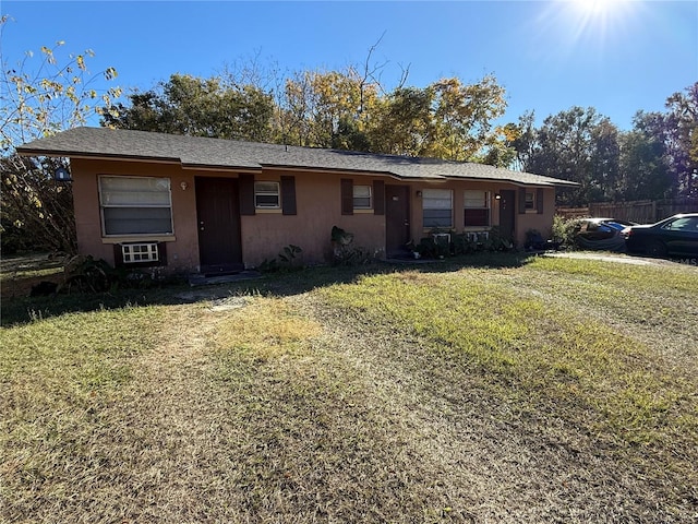 single story home featuring a front yard