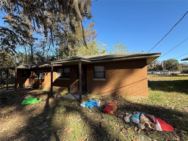 rear view of property with a yard