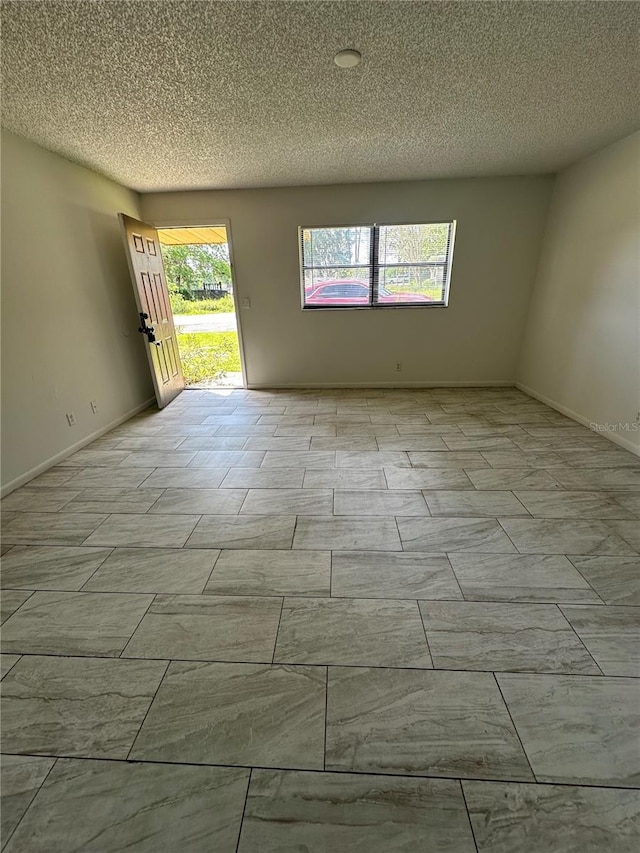 spare room with a textured ceiling