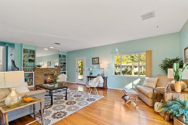 living room featuring light hardwood / wood-style flooring and built in features