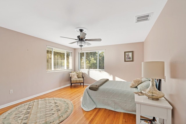 bedroom with light hardwood / wood-style floors and ceiling fan