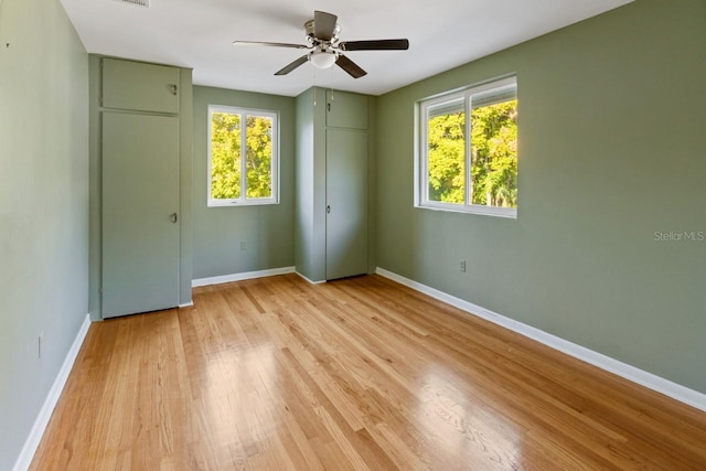 unfurnished bedroom with ceiling fan and light hardwood / wood-style floors