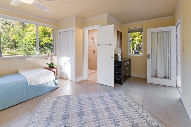 bedroom featuring ensuite bathroom, ceiling fan, crown molding, and light tile patterned flooring