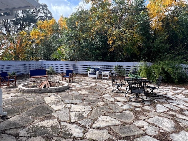 view of patio with a fire pit