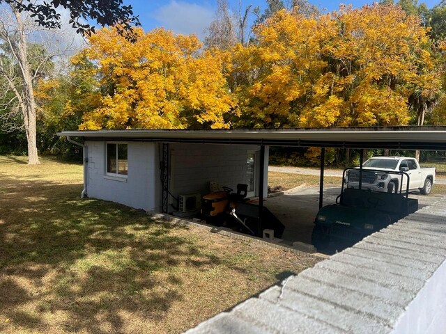 exterior space featuring a yard and a carport