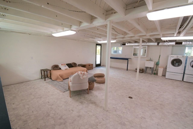 basement featuring independent washer and dryer and sink