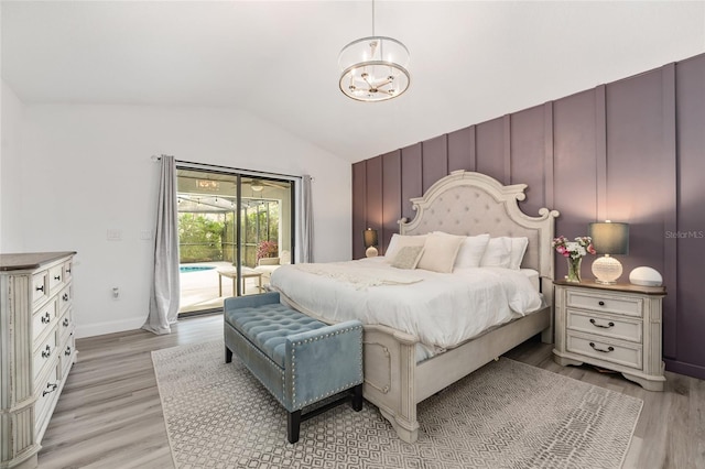 bedroom with access to exterior, light hardwood / wood-style floors, and vaulted ceiling