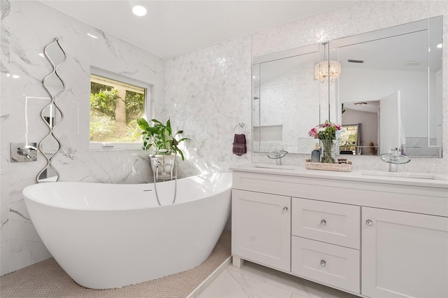 bathroom featuring a bath, vanity, and tile walls