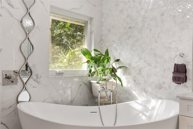 bathroom with a bathtub and tile walls