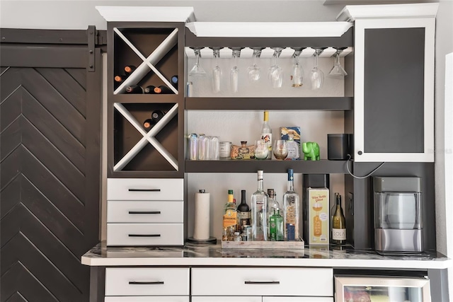 bar featuring wine cooler and white cabinetry