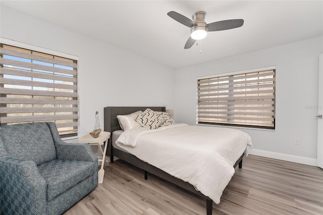 bedroom with ceiling fan and hardwood / wood-style floors